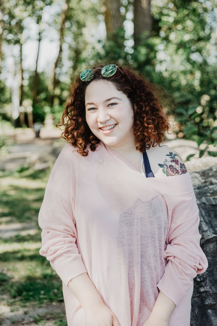 Young Woman With Curly Hair Smiling Bright