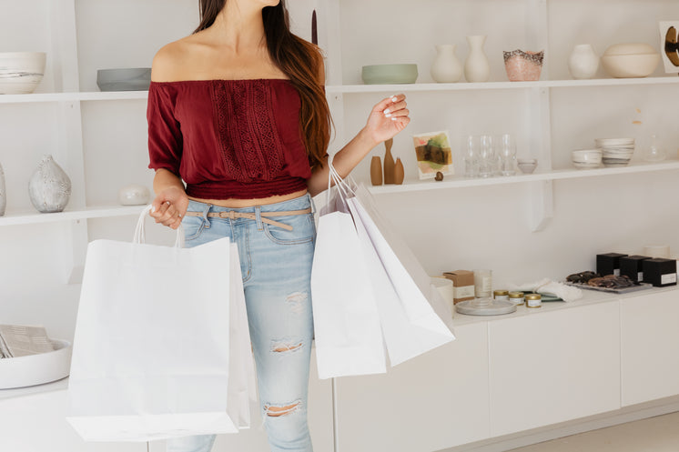 Young Woman With White Shopping Bags